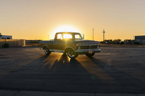 Restored truck at sunset in a parking lot with a coyote swap
