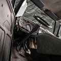 Close-up of a vintage car's interior with dashboard and 1965-66 Ford Truck Steering Column.
