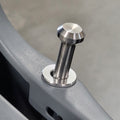 A close-up of a brushed silver metal mounting bolt with a flat washer and a knurled top, inserted into a gray metal frame.