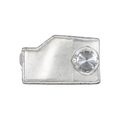 A brushed silver metal accessory with a textured, irregular border and a circular textured silver button on the right side, shown on a plain white background.