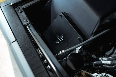 ECU mount with a FFG logo in a matte black engine bay