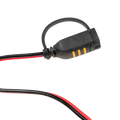 Black electrical connector with red and black wires on a white background