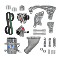 A complete automotive parts kit laid out on a white background, including an alternator, AC compressor, pump assembly, belts, hoses, metal brackets, studs, bolts, and other mounting hardware.