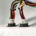 Two cable organizers with multicolored wires on a white background