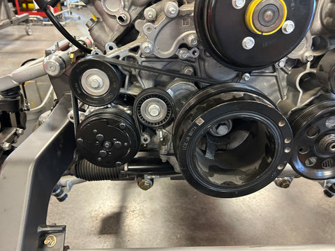 Close-up of a car engine with belts and pulleys