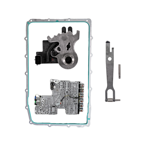 A set of automotive mechanical parts laid out on a white background, including a large gasket with a teal seal, a silver metal assembly, a smaller silver metal component, a small pin, and a black plastic connector.