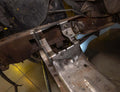 Motor mount kits installed on a chassis in a garage setting.